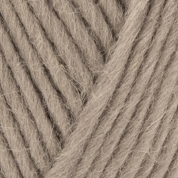 Close-up of beige yarn with visible texture