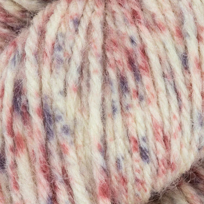 Close-up of a skein of multicolored yarn with red, purple, and beige tones.