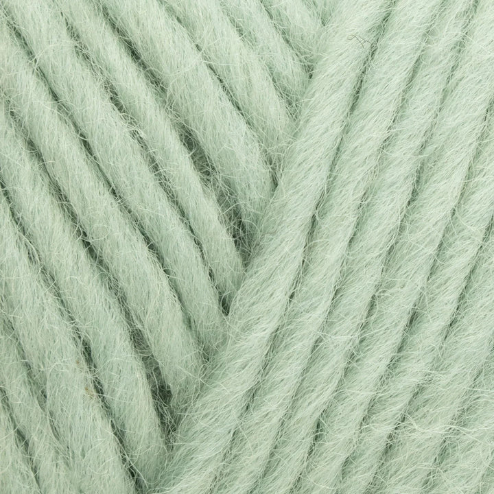 Close-up of light green yarn with a slight texture
