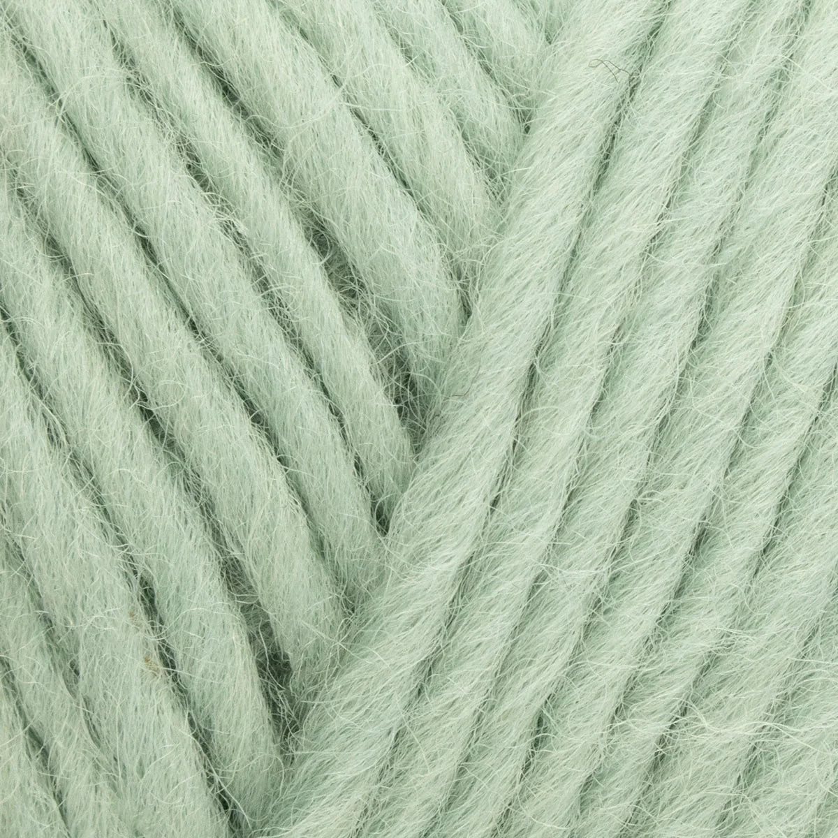 Close-up of light green yarn with a slight texture