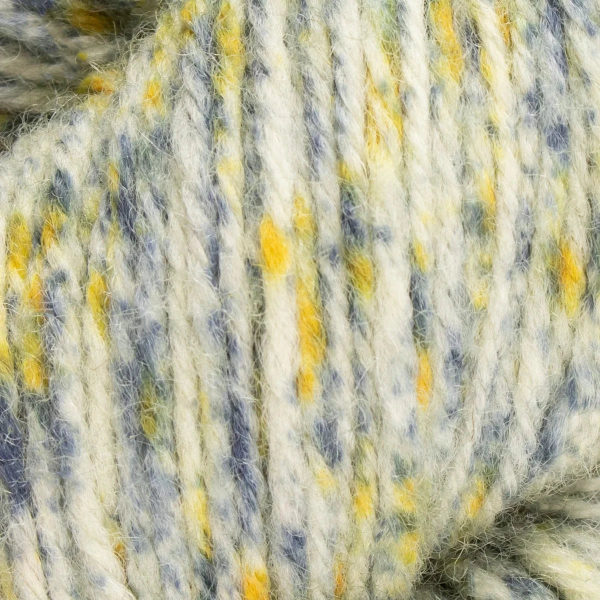 Close-up of a skein of yarn with blue, yellow, and white colors.