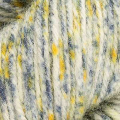 Close-up of a skein of yarn with blue, yellow, and white colors.